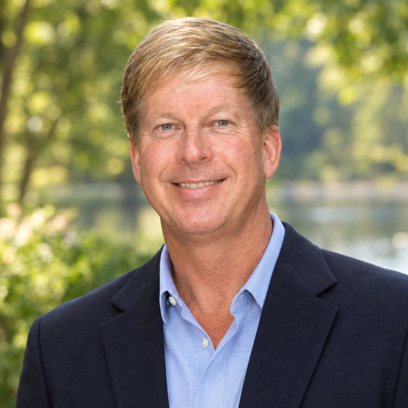 Headshot of Barry Royalty, LCSW, smiling outdoors in a navy blazer and light blue shirt.
